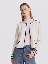 Woman wearing white cardigan and jeans